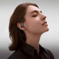 Bluetooth ear hook translator with Hi-Fi audio, worn by a person for real-time translation.